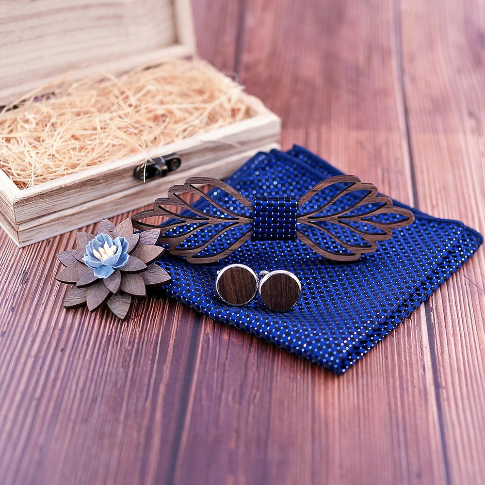 Nœud papillon en bois Laga et ses accessoires assortis : pochette, broche et boutons de manchette sur une table en bois pour un look chic et complet.